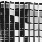 Property Success - Black and white of high contemporary multi storey office construction with same transparent windows