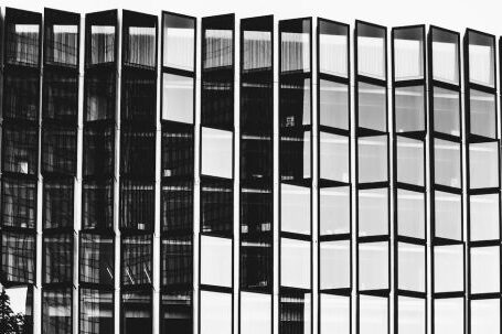 Property Success - Black and white of high contemporary multi storey office construction with same transparent windows