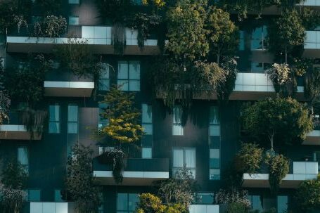 Property Investment - Modern residential building facade decorated with green plants