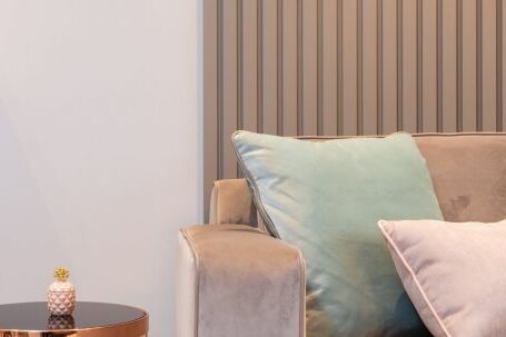 Property Investment: Tips - Soft cozy sofa with cushions placed near round coffee table in light contemporary living room