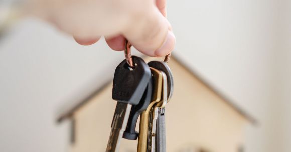Property Investment - Person with keys for real estate
